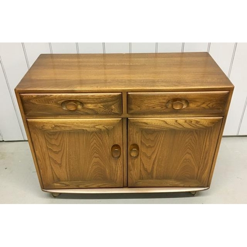 101 - An Ercol Windsor, dark elm sideboard/dining cabinet. Two drawers, over double cupboard. One drawer h... 