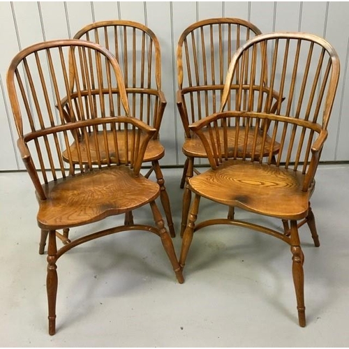 107 - A set of four, dark elm hoop-backed, Windsor armchairs. Dimensions(cm) H103(47 to seat), W53, D62.