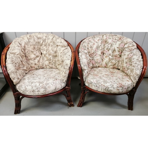 122 - A pair of cane conservatory chairs, with floral seat cushions. Dimensions(cm) H70(39 to seat), W73, ... 