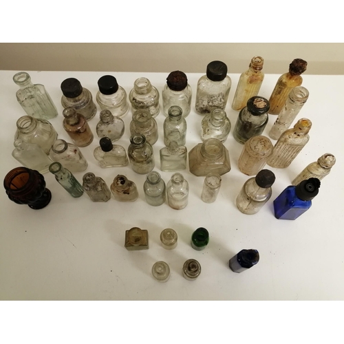 214 - A collection of forty miniature glass bottles. Mostly unbranded, but others include 'Stephens' & 'Ta... 