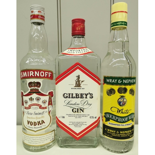 264 - A selection of three bottles of spirits. To include Smirnoff Vodka, Gilbey's Gin & Wray & Nephew Ove... 