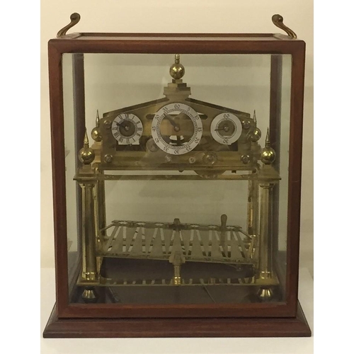 387 - A stunning 'Congreve', triple dial rolling ball brass clock in an oak/glazed case, set on an oak pli... 