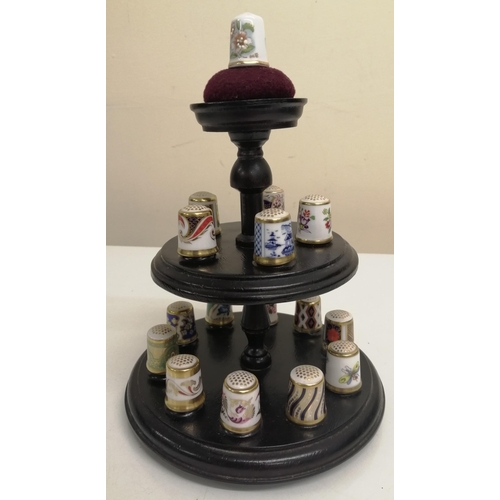 483 - A wooden thimble carousel stand, together with fifteen 'Crown Derby' ceramic thimbles & another by '... 