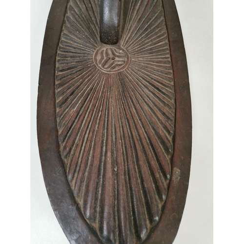 627 - A carved ornamental shelf, of likely African origin, depicting a boat & children scene and children.... 