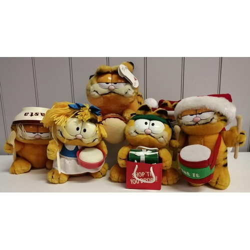 A collection of six Garfield soft toys, each with a food or Christmas theme.