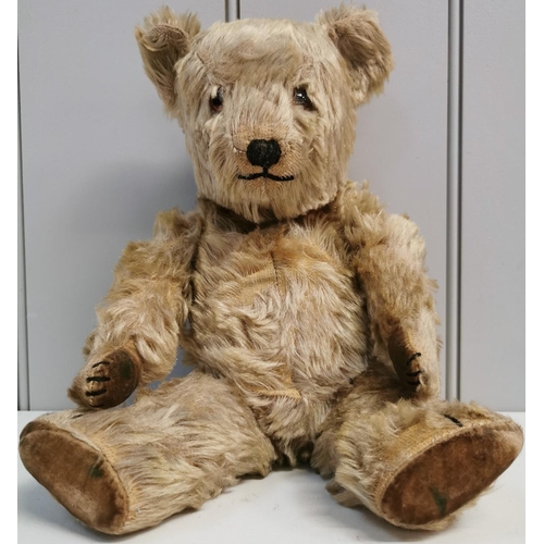 4086 - An early-mid 1900's, straw-filled teddy bear. Features include jointed limbs & squeaker(non-function... 