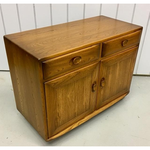 100 - An Ercol Windsor, dark elm sideboard/dining cabinet. Two drawers, over double cupboard. One drawer h... 