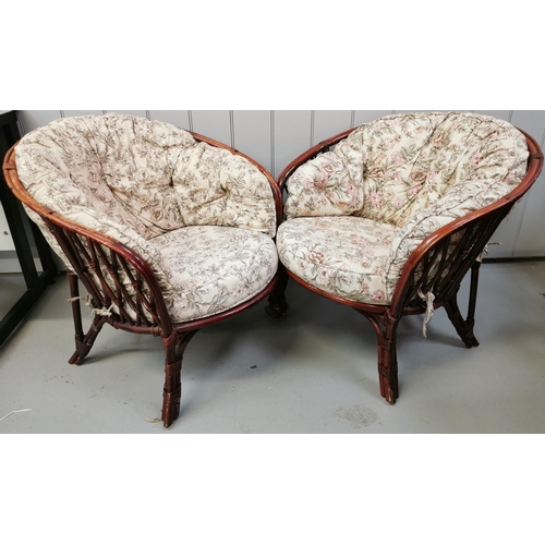 122 - A pair of cane conservatory chairs, with floral seat cushions. Dimensions(cm) H70(39 to seat), W73, ... 