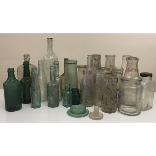 211 - A collection of approximately twenty-seven vintage glass bottles & jars. To include green examples f... 