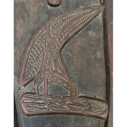 627 - A carved ornamental shelf, of likely African origin, depicting a boat & children scene and children.... 