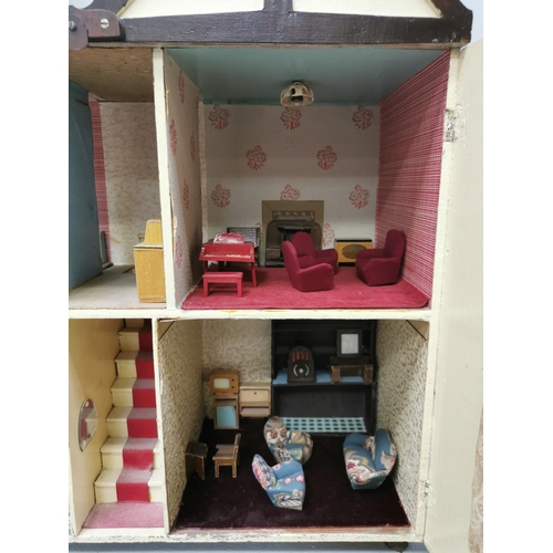 765 - A stunning, handmade dolls house c.1950's. Fully furnished with mid-century styling. Includes a larg... 