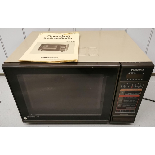 779 - A large, light brown 600w Panasonic microwave, model NE691. Complete with original with instruction ... 