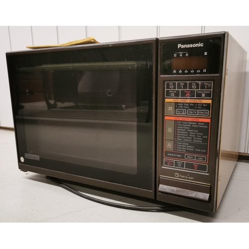 779 - A large, light brown 600w Panasonic microwave, model NE691. Complete with original with instruction ... 