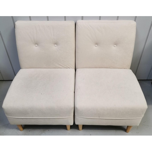 959 - A pair of cream fabric, cushioned, low set chairs. Dimensions(cm) H75(40 to seat), W50, D65.