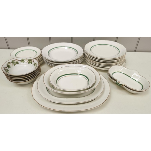 1389 - A thirty-eight-piece dinner service, in white with green & gold border detail, together with a set o... 