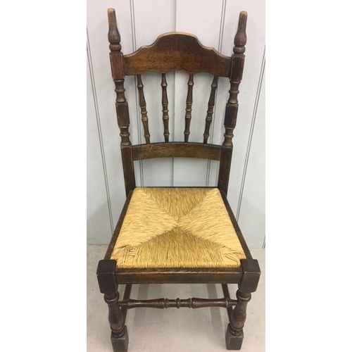 145A - A set of four oak/rush-reed chairs. Dimensions(cm) H104(44 to seat), W46, D50.