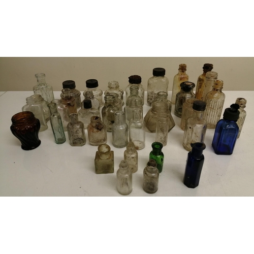 214 - A collection of forty miniature glass bottles. Mostly unbranded, but others include 'Stephens' & 'Ta... 