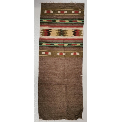 199F - A small Kelim-style rug. Dimensions 124cm x 47cm. Wear to one side.