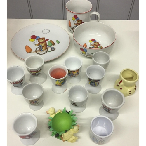 536 - A collection of children's egg cups. To include 'Babar', 'Tweenie', 'Bob the Builder' etc., together... 