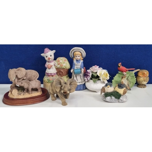 581 - An assortment of eight decorative ceramic & resin figurines, mostly animal themed. Two collectible c... 