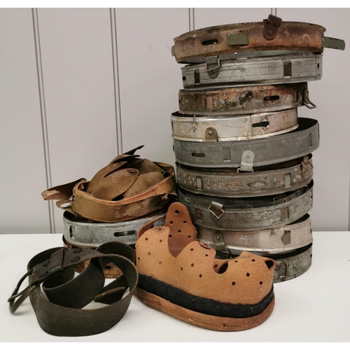 215 - A selection of mostly WWII German helmet liners & inners, together with a leather belt.