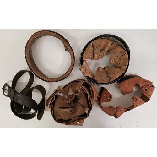 215 - A selection of mostly WWII German helmet liners & inners, together with a leather belt.