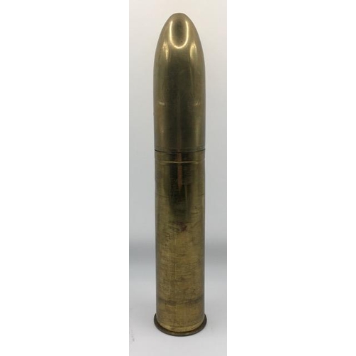 224 - Trench Art - A large calibre, brass shell case converted to a table lighter. Length 24cm.