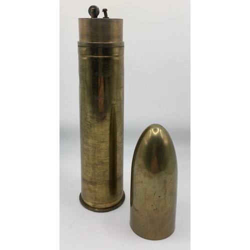 224 - Trench Art - A large calibre, brass shell case converted to a table lighter. Length 24cm.