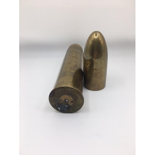 224 - Trench Art - A large calibre, brass shell case converted to a table lighter. Length 24cm.