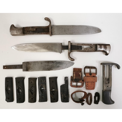 295 - A mixed lot of three German WWII daggers (without handle grips), belt buckles & other dagger grips. ... 