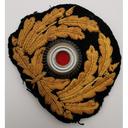 316 - A WWII German Kriegsmarine Officer's cap wreath/cockade & Eagle pin.