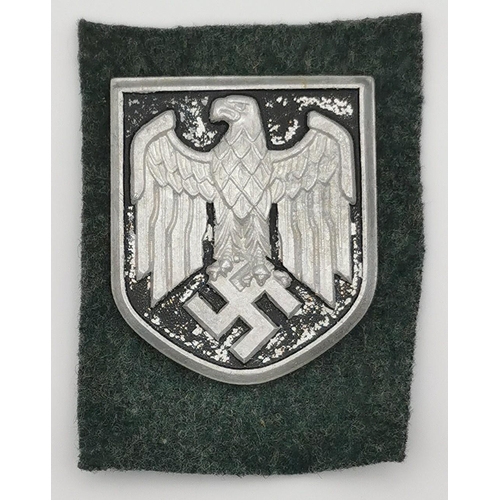 323 - A WWII German Pith helmet insignia shield.