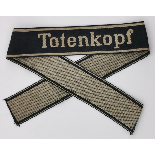 326 - A WWII Waffen Panzer Division SS 'Totenkopf' cuff title. Complete with note of provenance from vendo... 