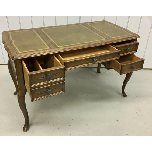 74 - A Louis XV style, walnut desk. Features a false fronted filing drawer, central drawer & two further ... 