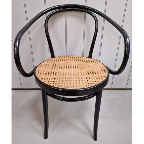 22 - A vintage, Thonet armchair. Ebony-coloured frame, with rattan seat. Made by 'ZPM Radomsko' in the 19... 