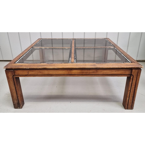 99 - A sectional glass-topped coffee table. 'Window-effect' top with four removable glass sections. Dimen... 