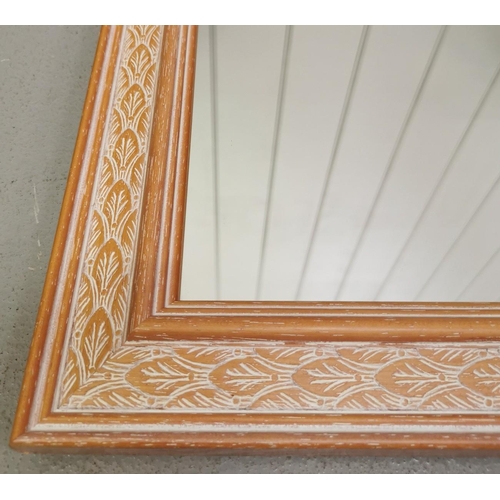 102 - A pretty-framed wall mirror. Dimensions 60cm x 85cm.