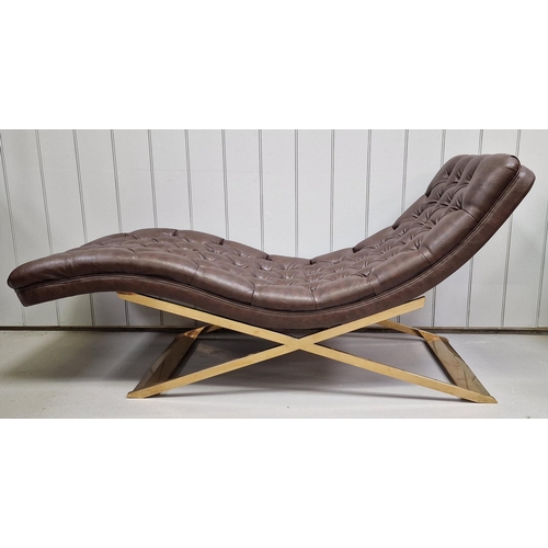 120 - A stylish, contemporary chaise longue. Upholstered in brown buttoned leather, supported by a gold-co... 