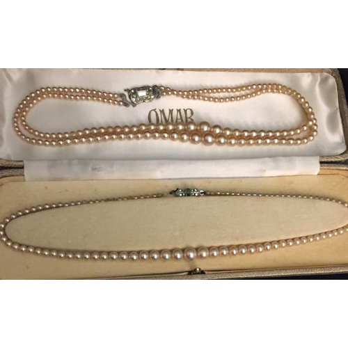 855 - An 'Omar De Luxe' box with two sets of graduated pearls. one single & one double stranded.