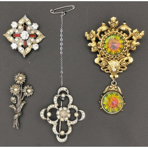 868 - A collection of four pretty brooches. To include a silver bouquet example, together with three other... 