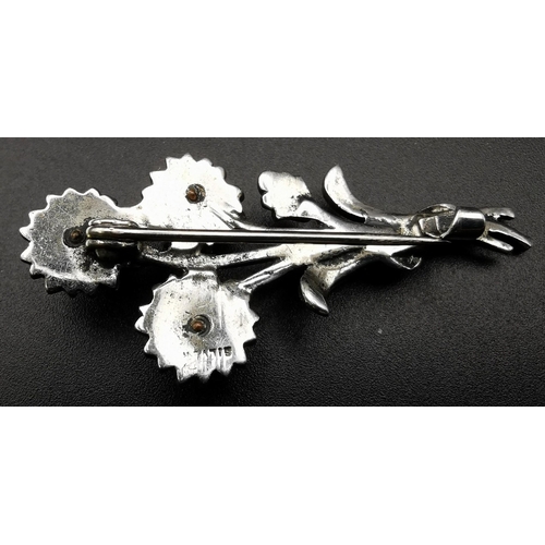 868 - A collection of four pretty brooches. To include a silver bouquet example, together with three other... 