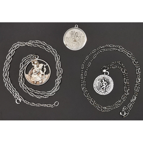 869 - A silver St Christopher with silver chain, weight approx. 18.9g, together with two other white metal... 