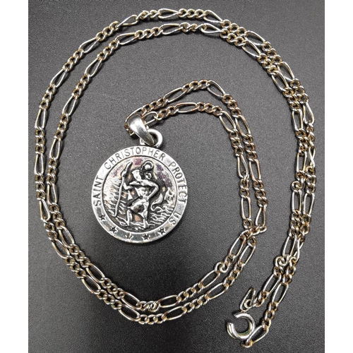 869 - A silver St Christopher with silver chain, weight approx. 18.9g, together with two other white metal... 