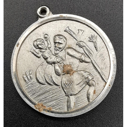 869 - A silver St Christopher with silver chain, weight approx. 18.9g, together with two other white metal... 