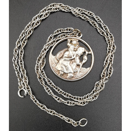 869 - A silver St Christopher with silver chain, weight approx. 18.9g, together with two other white metal... 