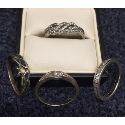 874 - A mixed lot, to include four hallmarked silver rings, three 'Swarovski Elements' earrings (appear un... 