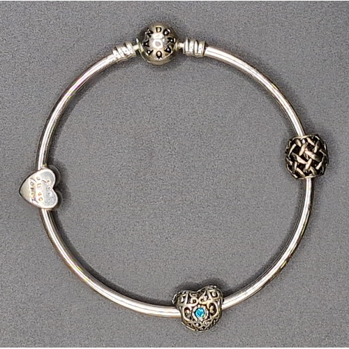 875 - A silver 'Pandora' charm bracelet, with three charms, together with a pair of white metal bangles.