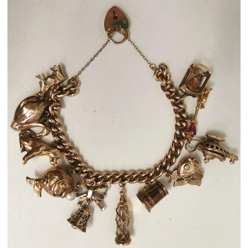 888 - A vintage 9ct gold charm bracelet. To include twelve individual charms. Each charm, chain & lock ful... 