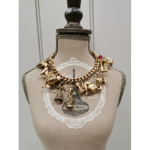 888 - A vintage 9ct gold charm bracelet. To include twelve individual charms. Each charm, chain & lock ful... 