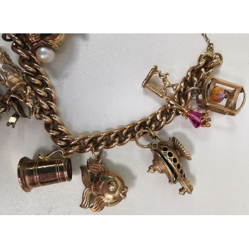 888 - A vintage 9ct gold charm bracelet. To include twelve individual charms. Each charm, chain & lock ful... 